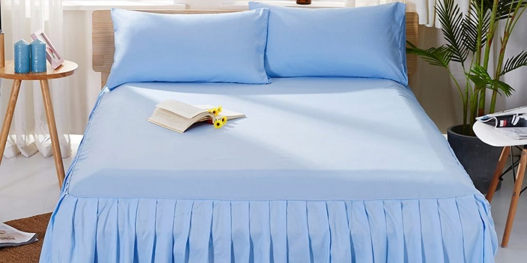 bed with blue bed skirt