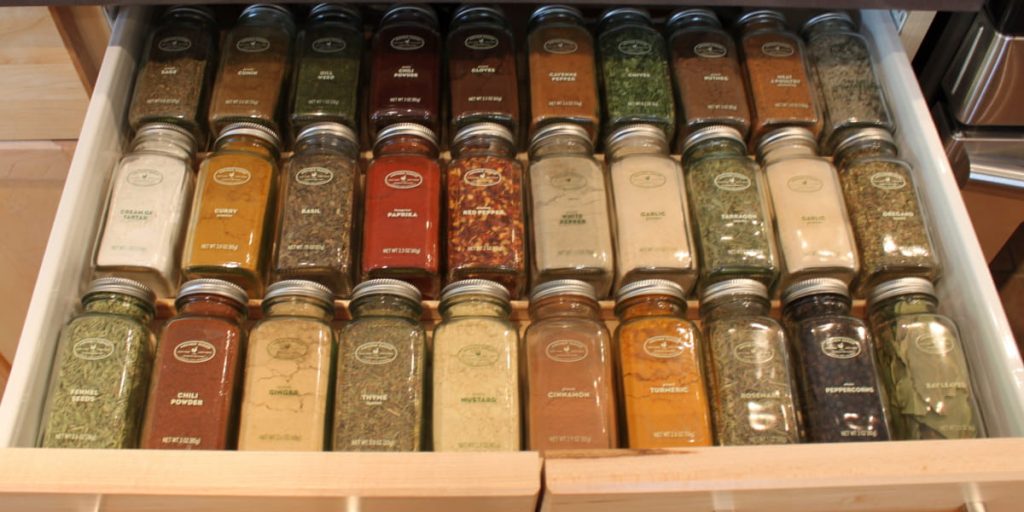 drawer full of bottles with spices