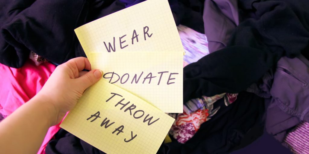 holding notes which go "wear, donate, throw away"