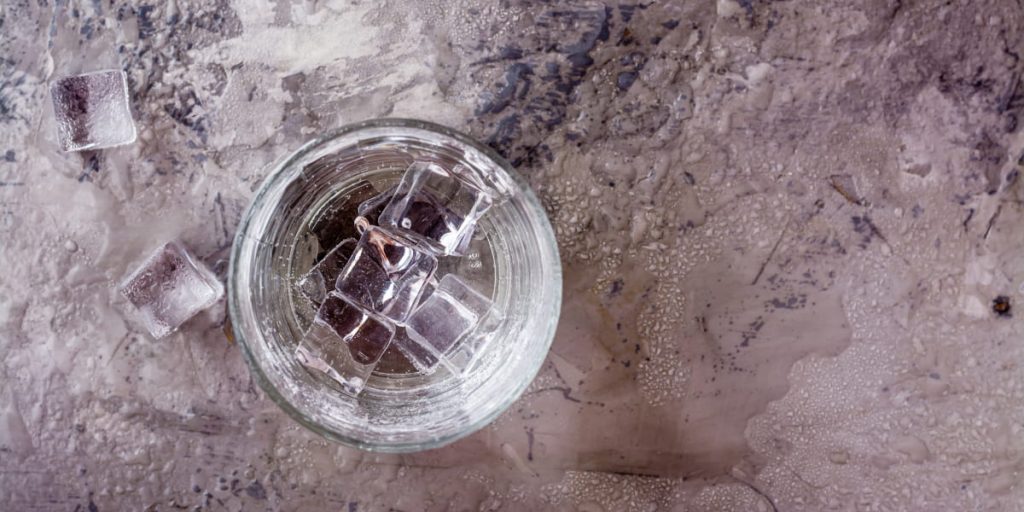 glass of water with ice on the table