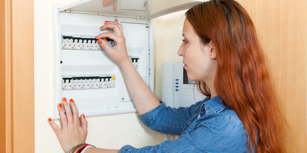 woman is managing fuse box