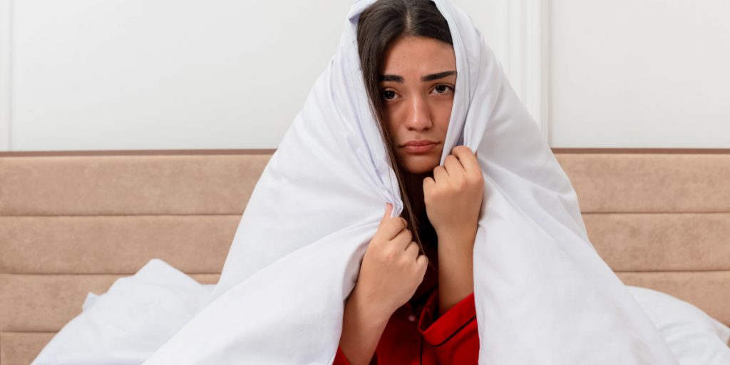 woman with white blanket over her head