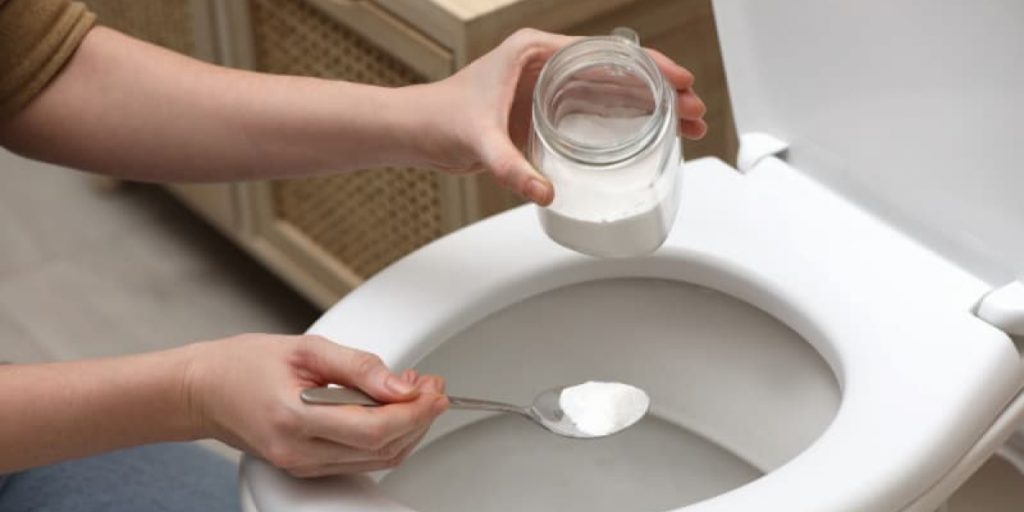 clearing a clogged toilet with baking soda and vinegar