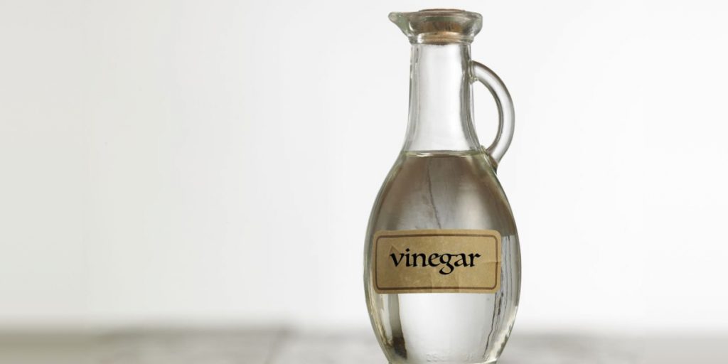 a bottle of vinegar on white background