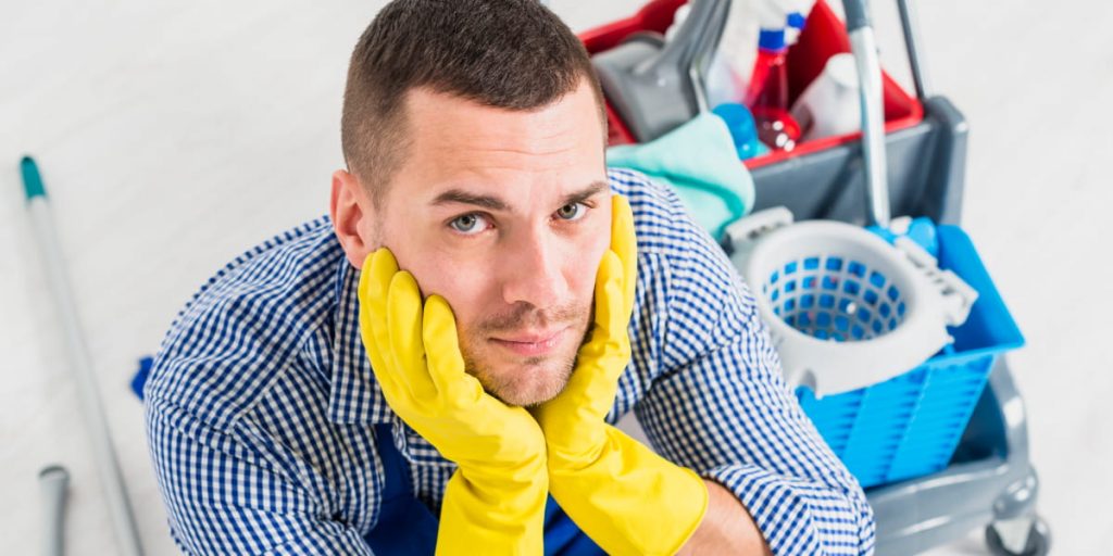 man in yellow cleaning gloves
