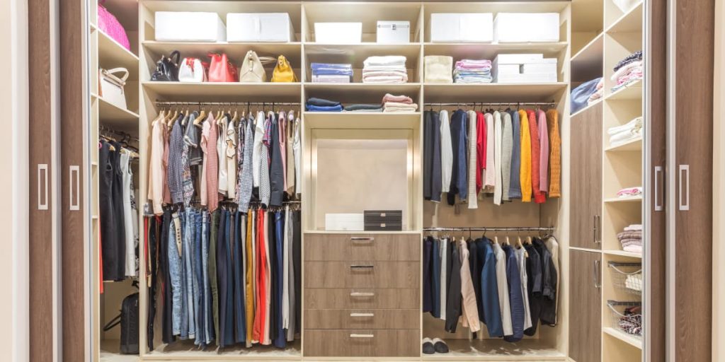 clothes organized by color in closet