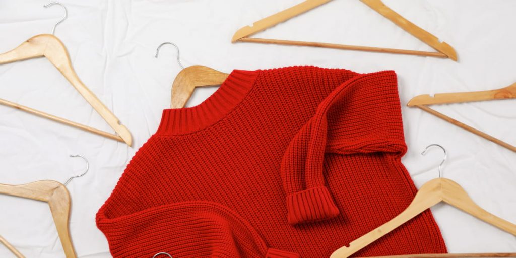 red sweater with hangers