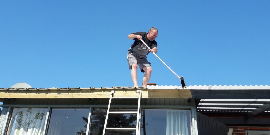 man cleaning roof tile