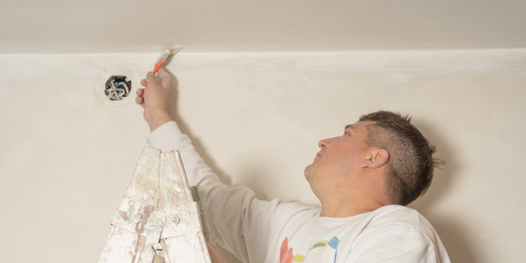 man paint a ceiling