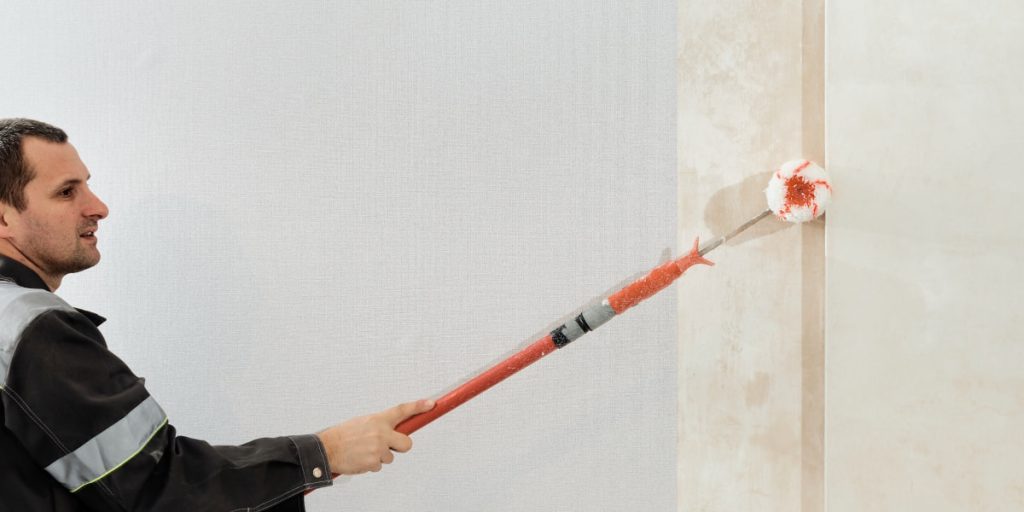 man show how to paint on wallpaper