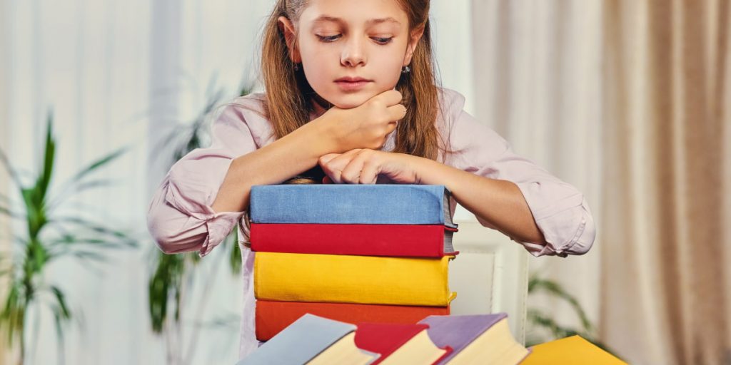 girl arrange books by color